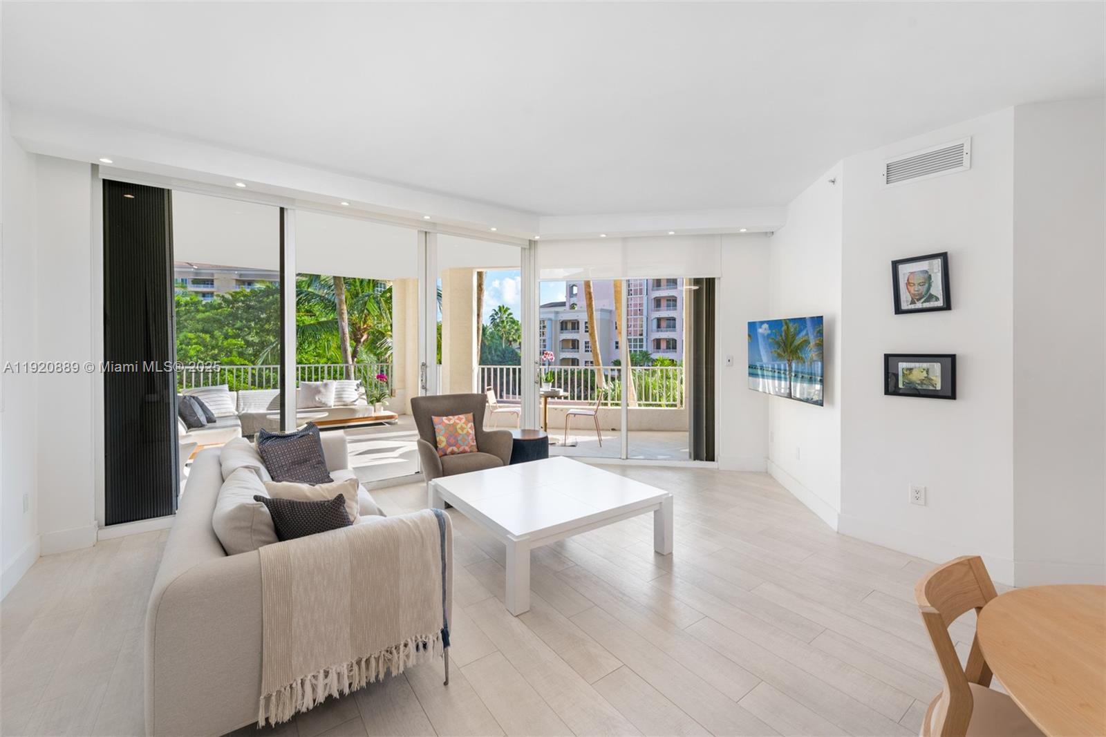 a living room with furniture and large windows