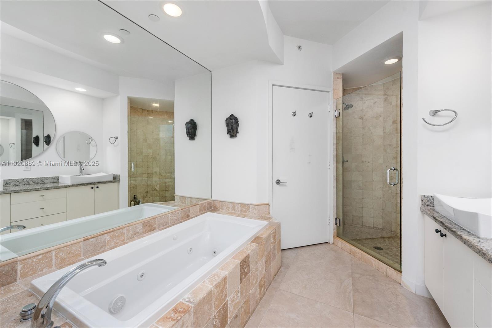 715 Crandon Boulevard, Unit 305 Key Biscayne, FL 33149 - Photo 11 of 20 a spacious bathroom with a tub sink shower and mirror