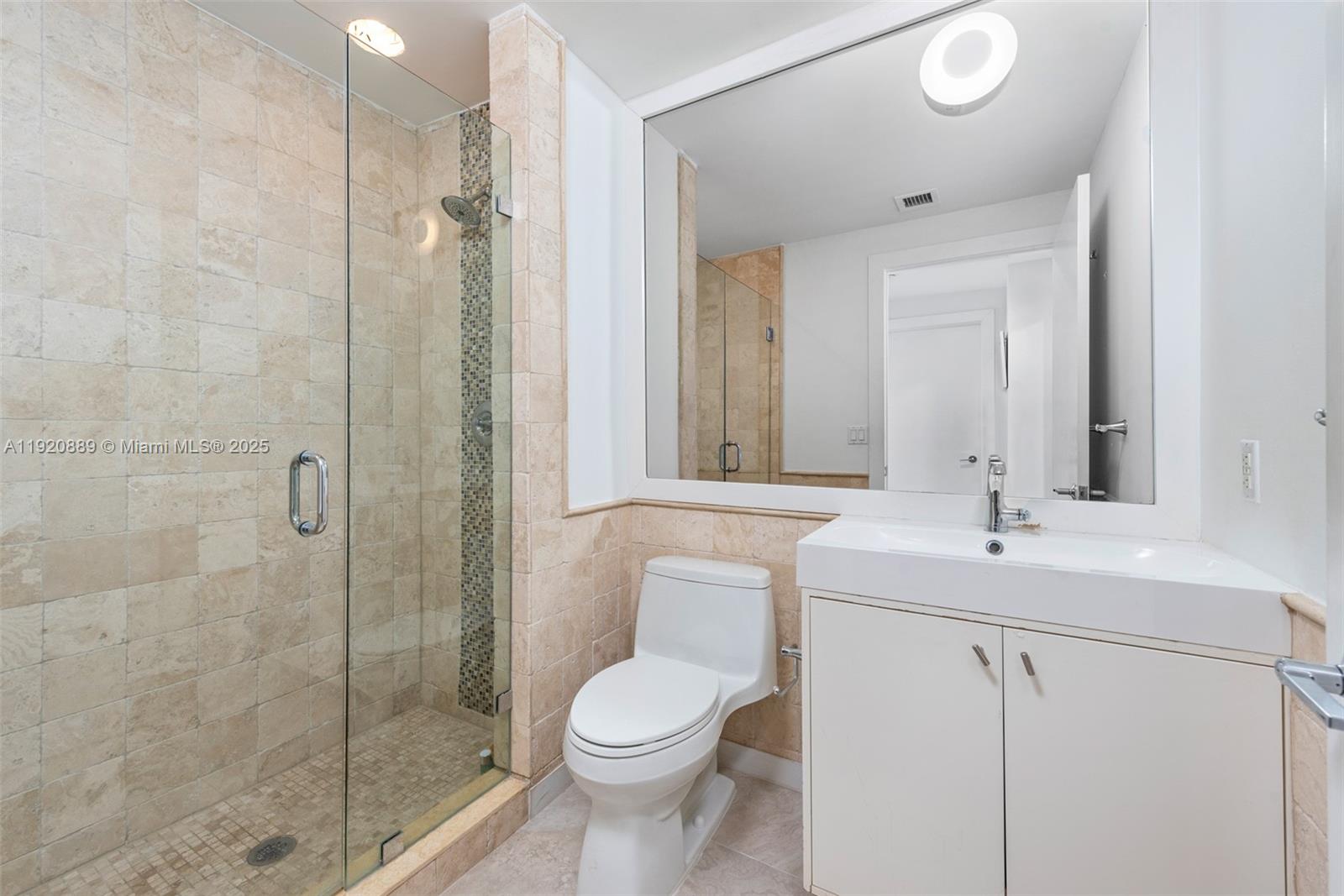 715 Crandon Boulevard, Unit 305 Key Biscayne, FL 33149 - Photo 12 of 20 a bathroom with a sink toilet and shower
