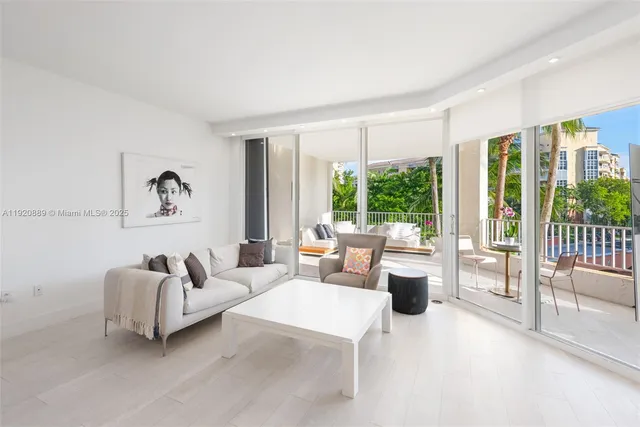 a living room with furniture and large windows