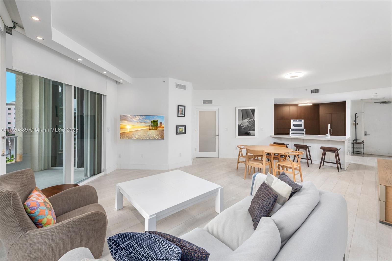 715 Crandon Boulevard, Unit 305 Key Biscayne, FL 33149 - Photo 3 of 20 a living room with furniture and a flat screen tv