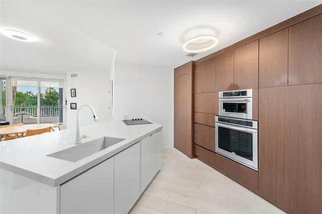 a kitchen with stainless steel appliances a stove a microwave and a sink