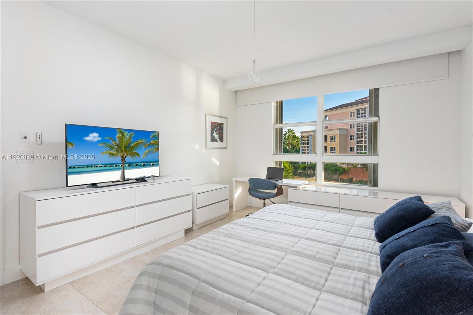 715 Crandon Boulevard, Unit 305 Key Biscayne, FL 33149 - Photo 6 of 20 a bedroom with a bed and a flat screen tv