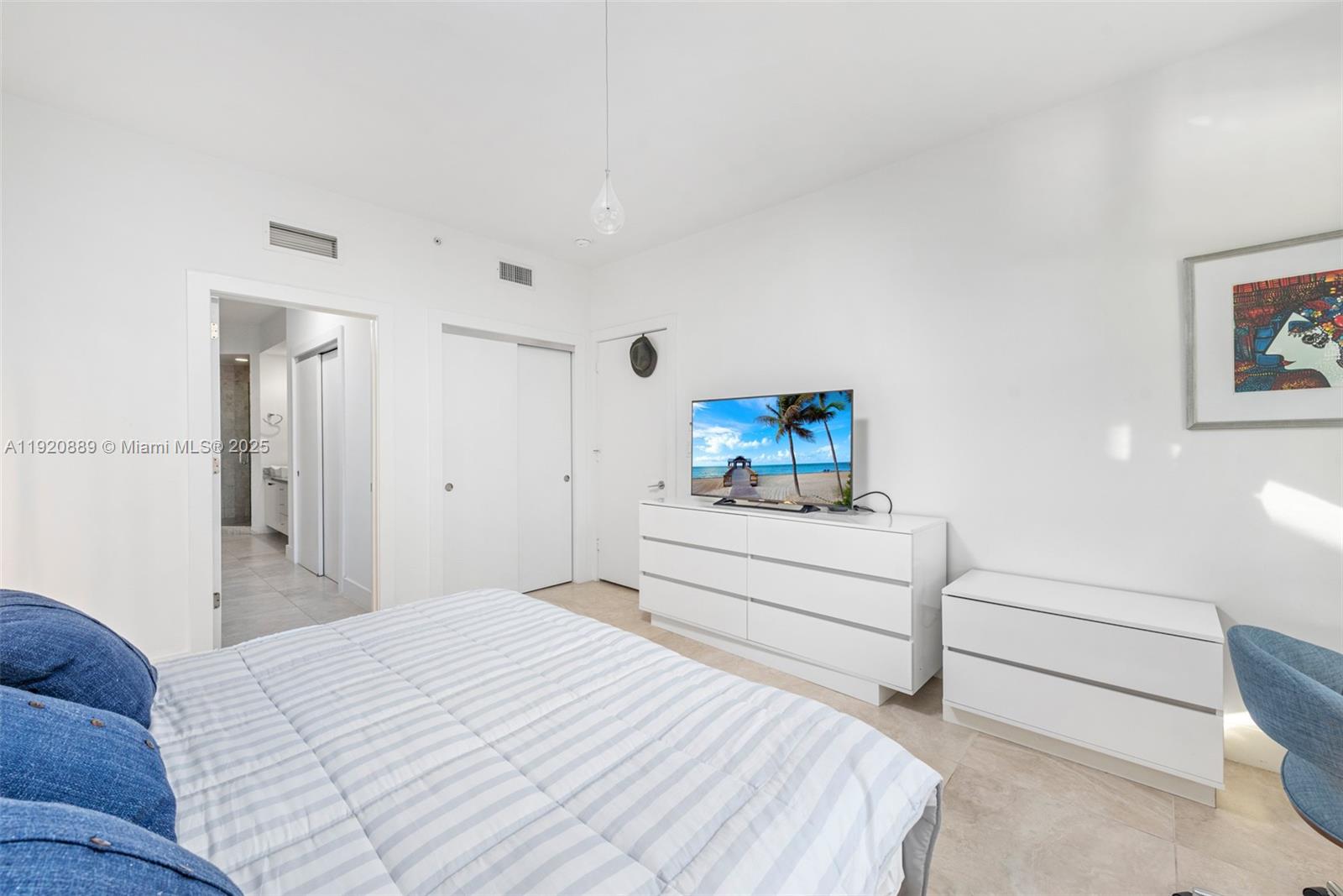 715 Crandon Boulevard, Unit 305 Key Biscayne, FL 33149 - Photo 7 of 20 a bedroom with a bed and a dresser