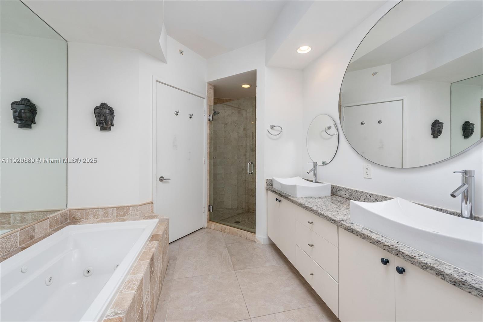 715 Crandon Boulevard, Unit 305 Key Biscayne, FL 33149 - Photo 10 of 20 a spacious bathroom with a granite countertop sink mirror and bathtub