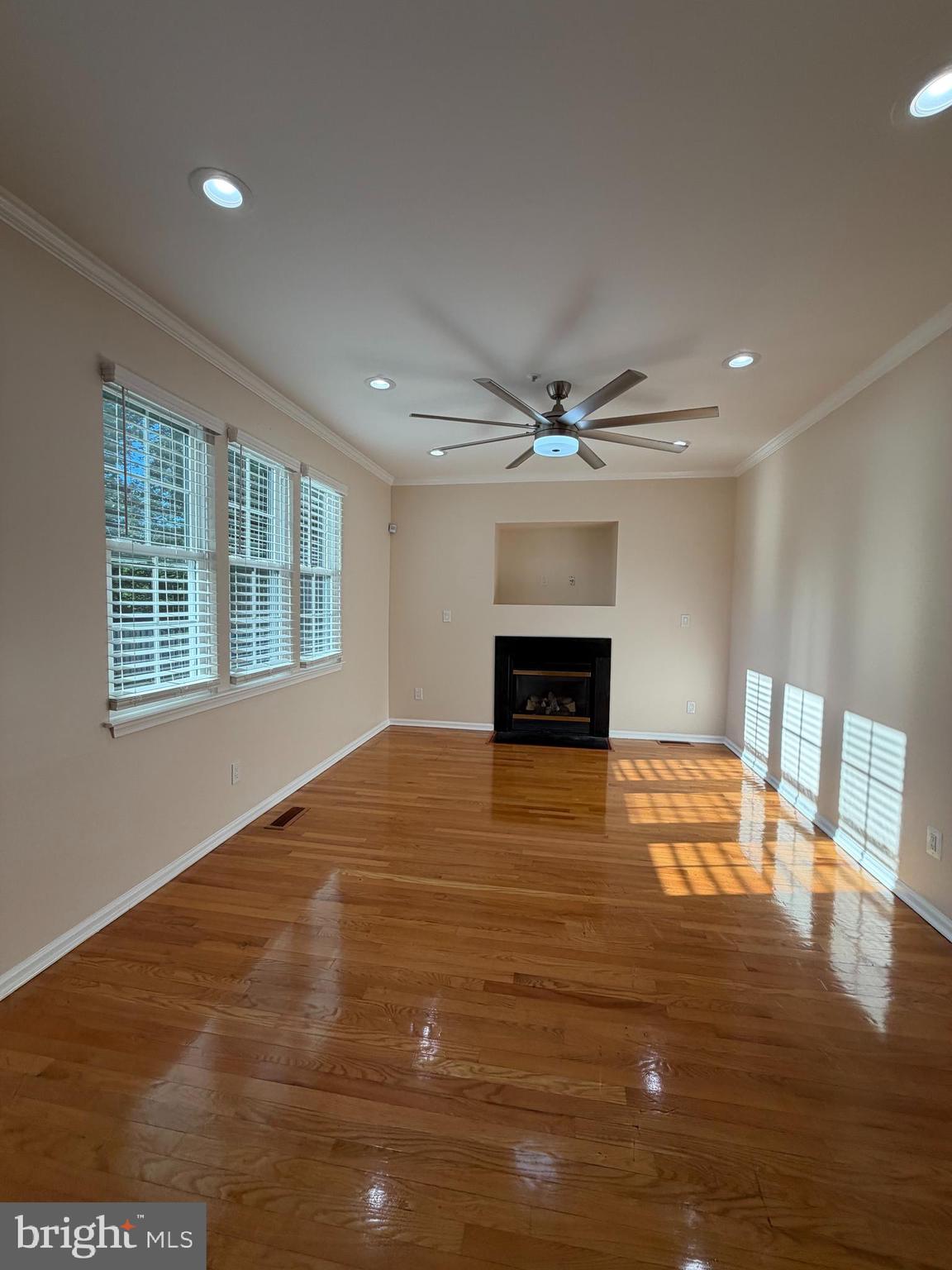 13952 Bishops Bequest Road Upper Marlboro, MD 20772 - Photo 9 of 28 a view of empty room with wooden floor and fireplace