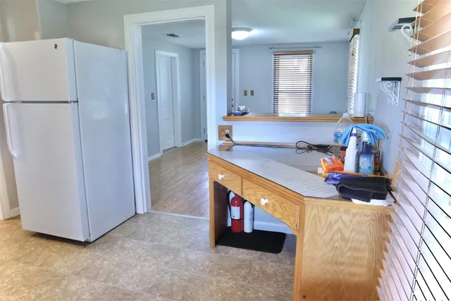 a bathroom with a granite countertop sink a mirror a vanity and a shower