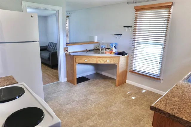 a view of a kitchen with a sink a microwave and cabinets