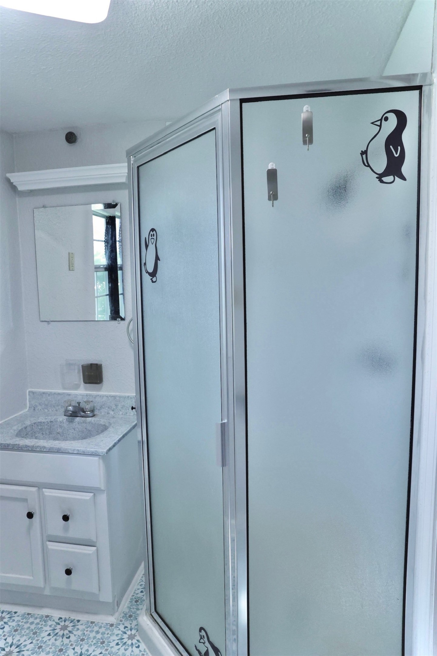 503 State Highway 95 Granger, TX 76530 - Photo 23 of 39 a bathroom with a granite countertop sink a mirror a vanity and shower