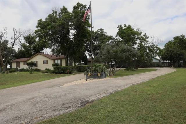 a view of a house with a tree