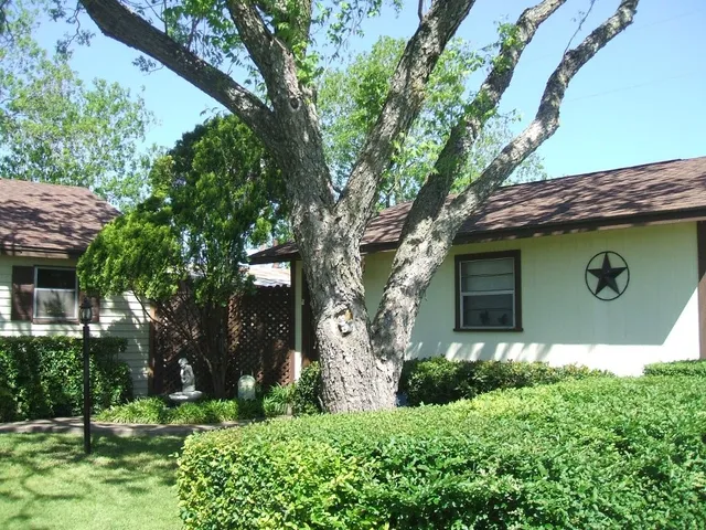 a view of a backyard with sitting area