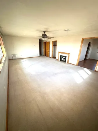 a kitchen with kitchen island a counter top space a stove and a refrigerator