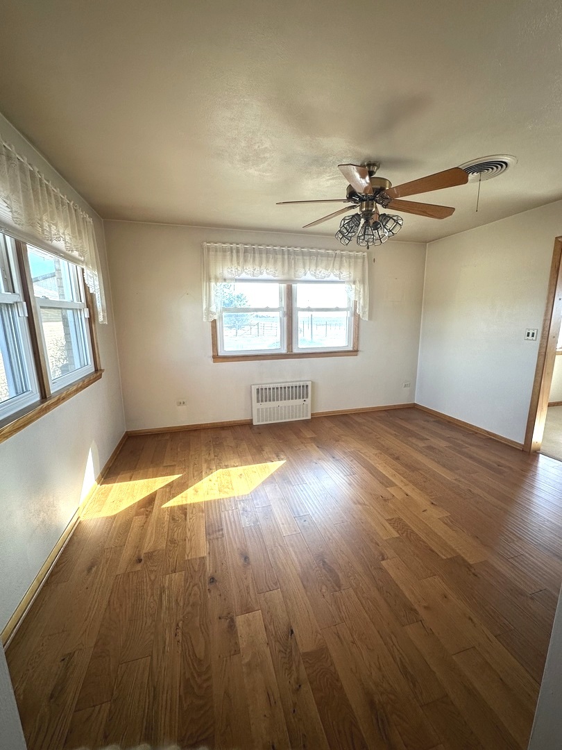 29428 East 500 North Road Le Roy, IL 61752 - Photo 17 of 79 an empty room with wooden floor chandelier and windows