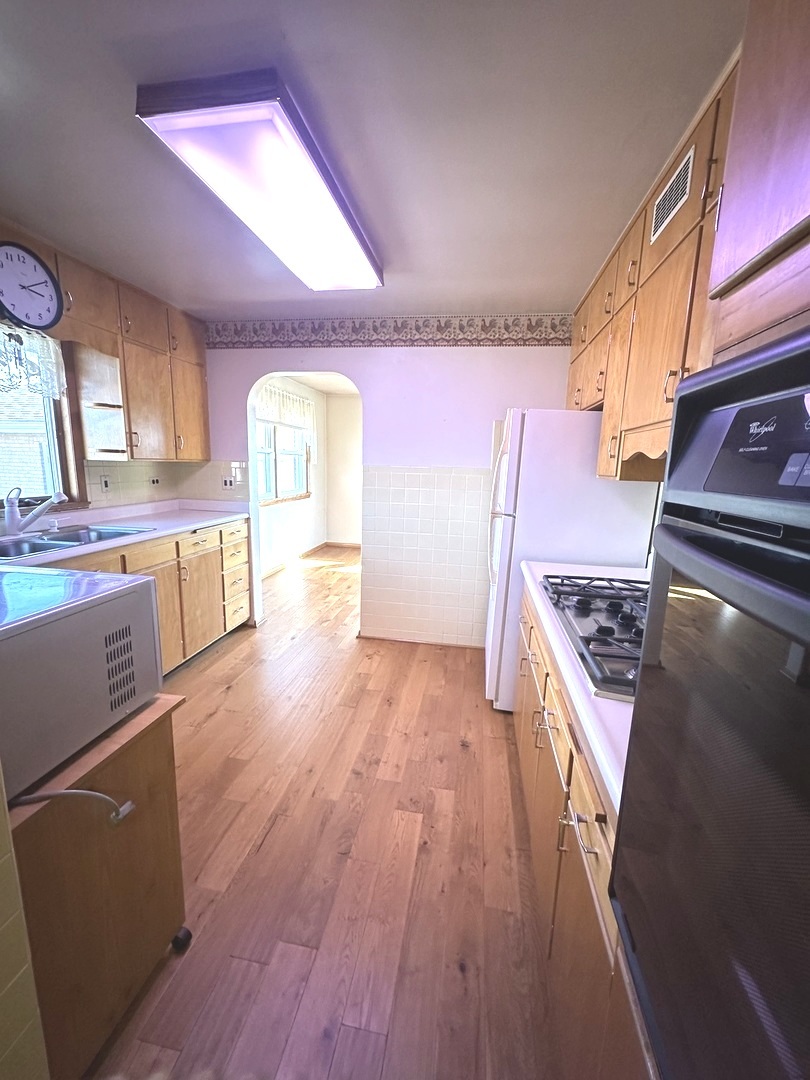 29428 East 500 North Road Le Roy, IL 61752 - Photo 20 of 79 a kitchen with wooden floors and a stove top oven