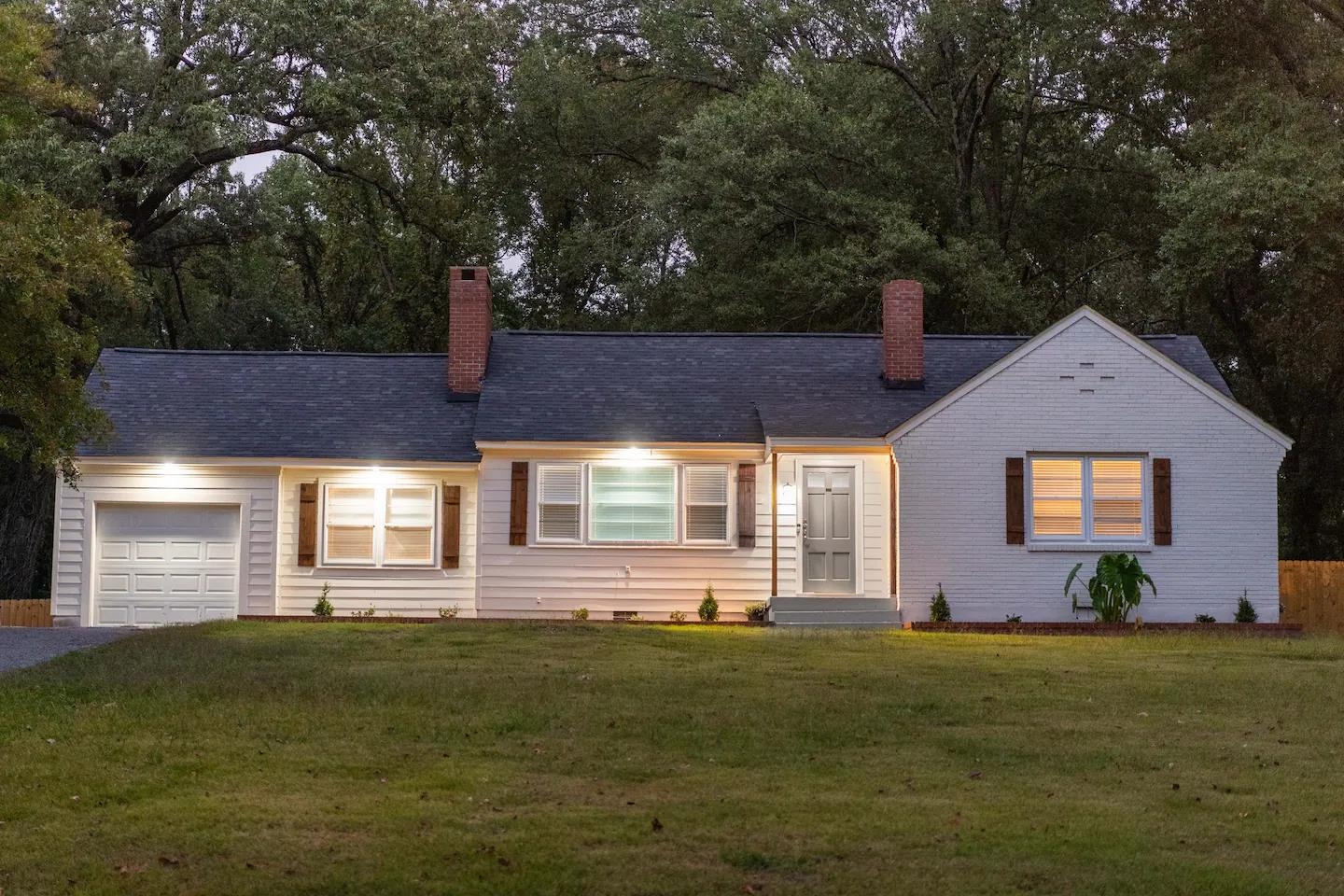 a front view of house with yard and green space