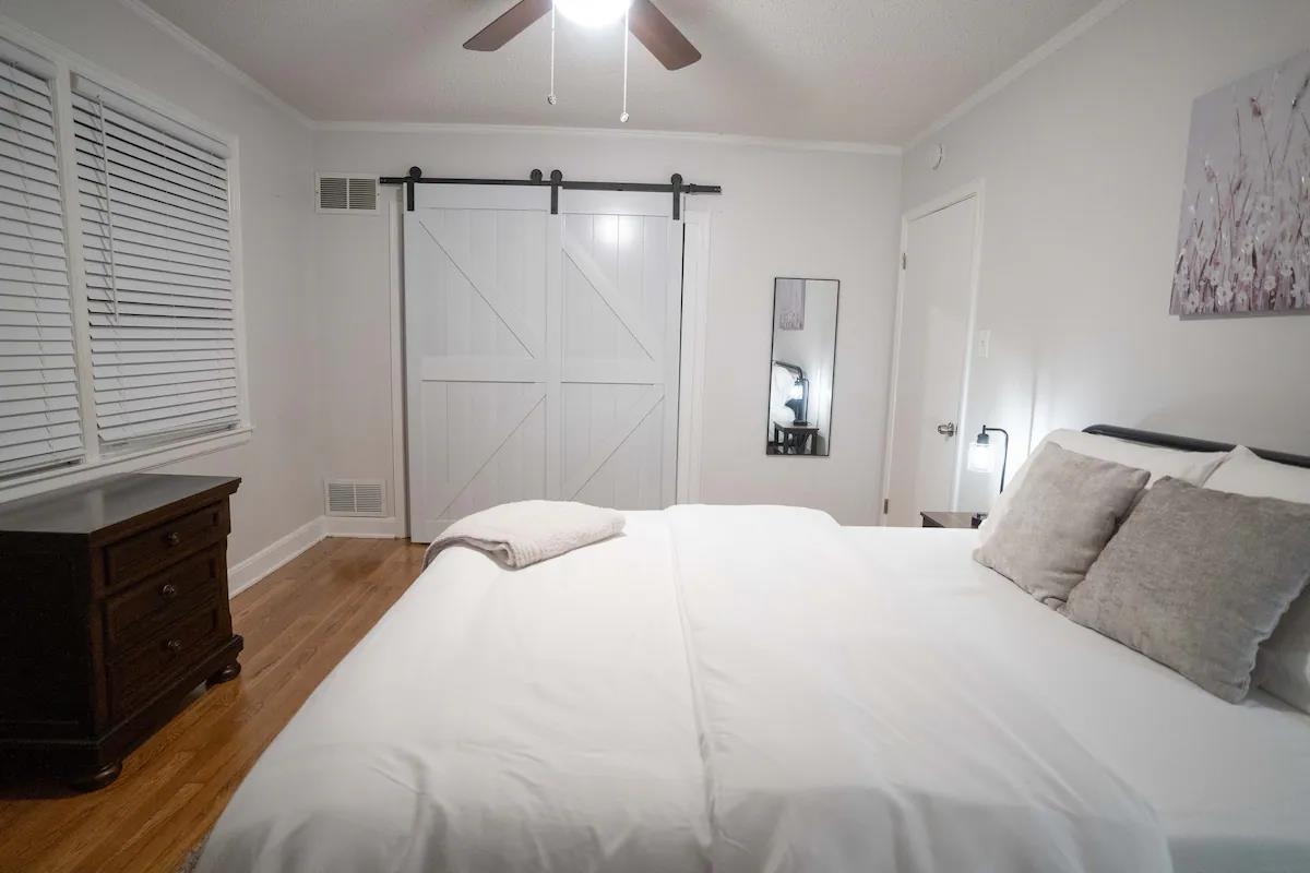 3506 McCorkle Road Memphis, TN 38116 - Photo 9 of 12 a bedroom with a bed and a chandelier