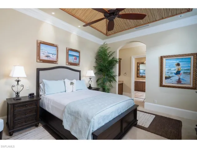 a bedroom with a bed and a painting on the wall