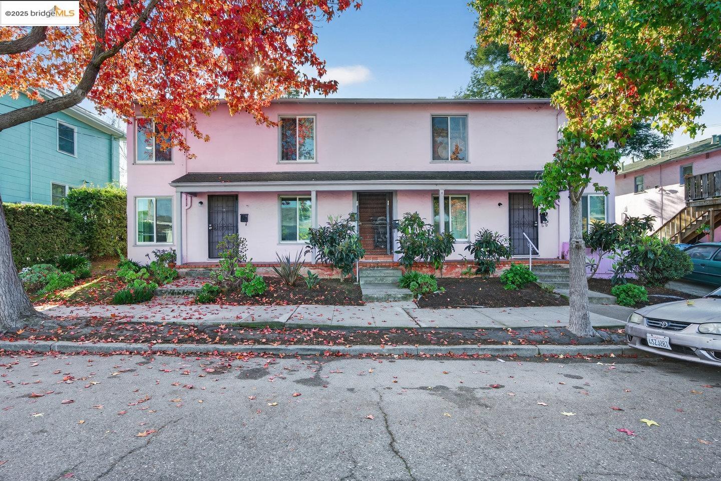 a front view of a house with a garden and plants