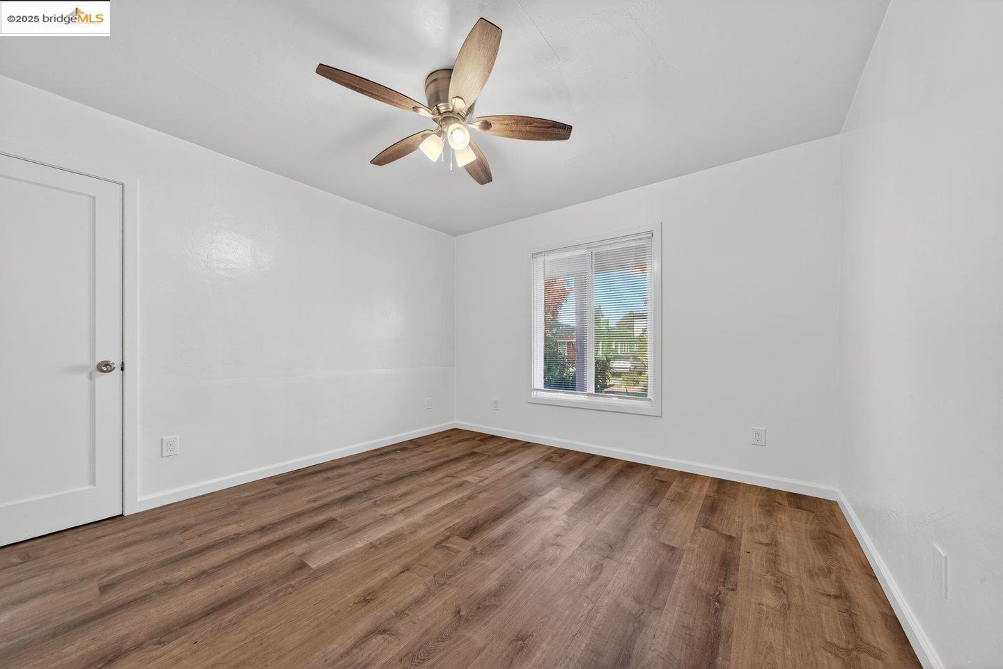 1408 Berkeley Way Berkeley, CA 94702 - Photo 18 of 22 a view of an empty room with wooden floor and a window