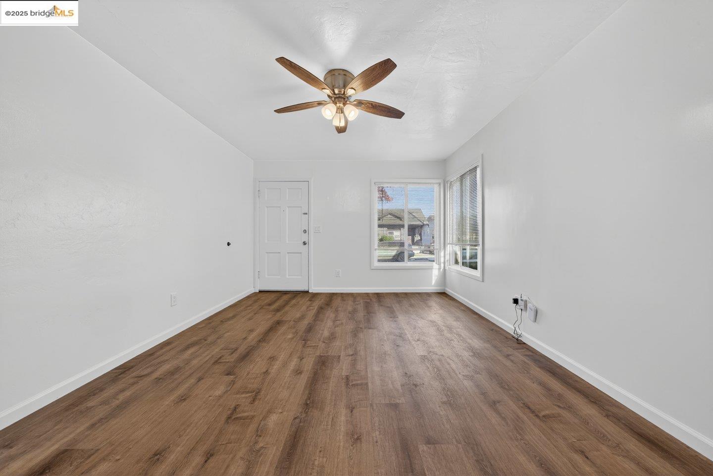 1408 Berkeley Way Berkeley, CA 94702 - Photo 20 of 22 a view of empty room with wooden floor and fan
