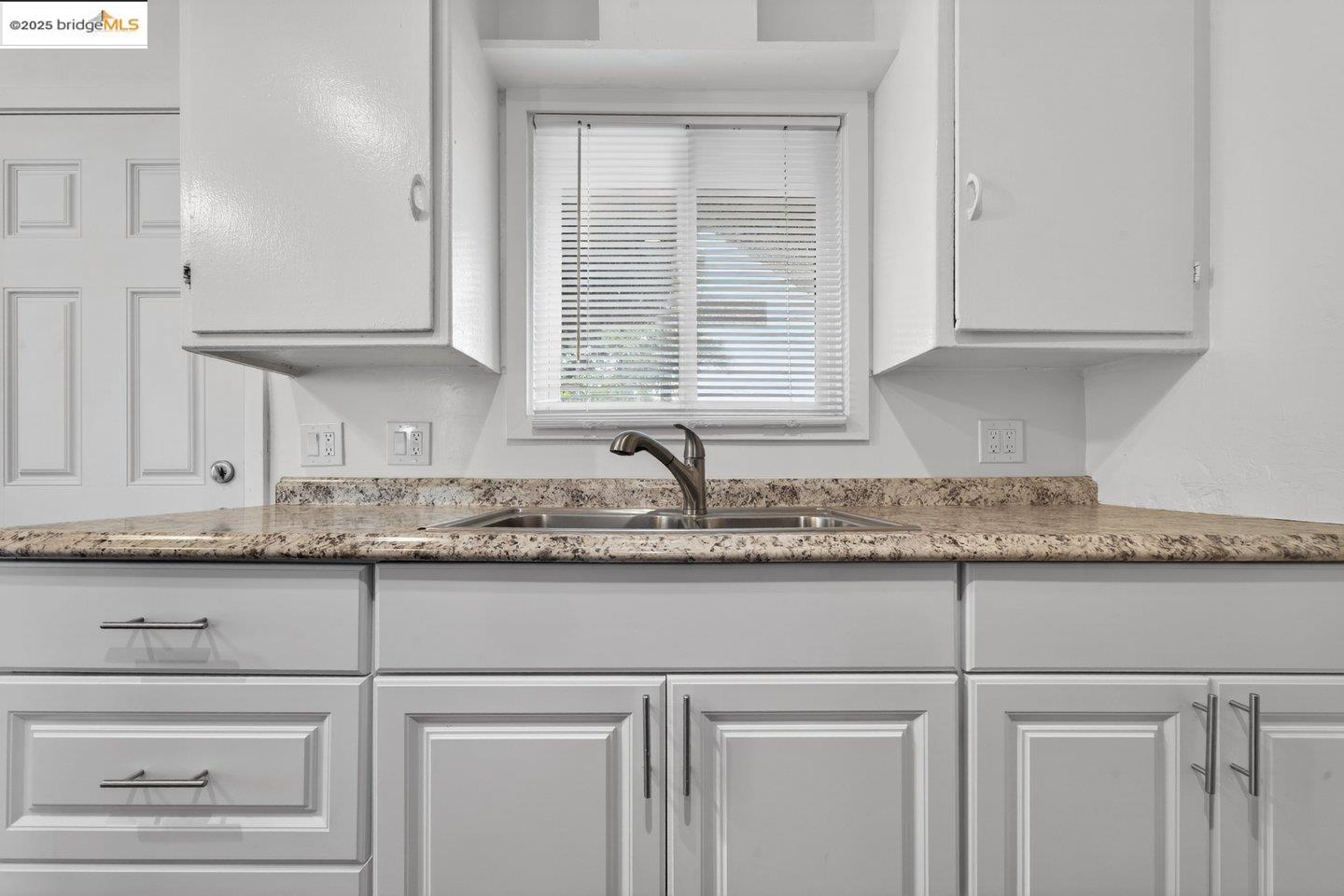 1408 Berkeley Way Berkeley, CA 94702 - Photo 7 of 22 a kitchen with granite countertop white cabinets and a sink