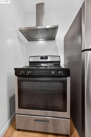 a stove top oven sitting inside of a kitchen