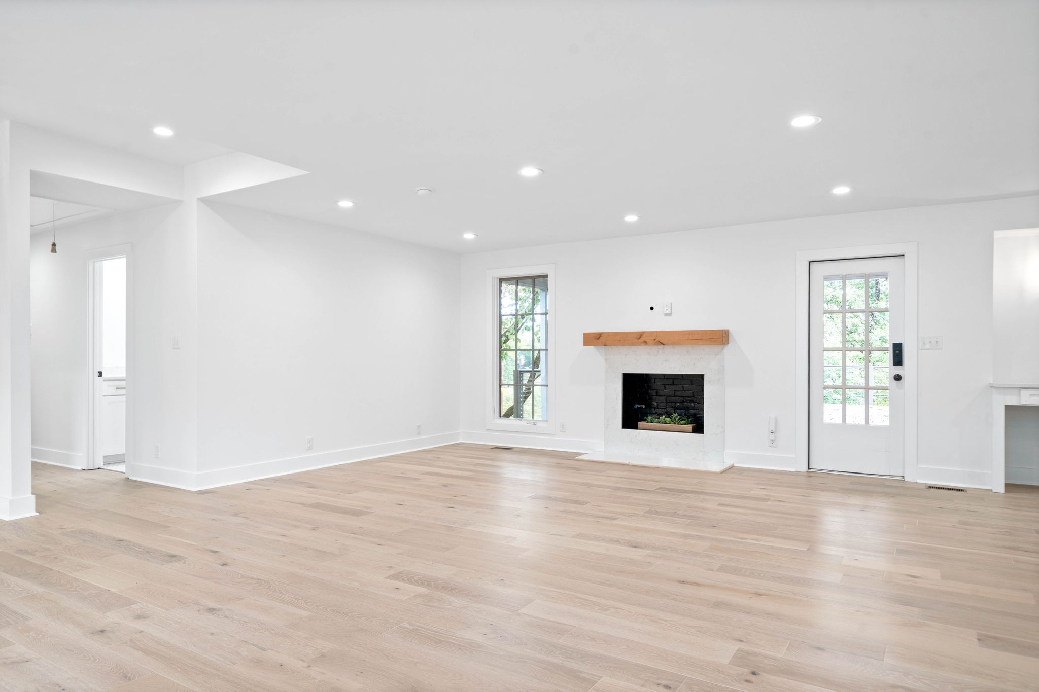 493 Georgetown Road Clarksville, TN 37043 - Photo 7 of 42 an empty room with wooden floor and fireplace