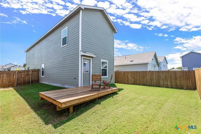 a view of a backyard with sitting area