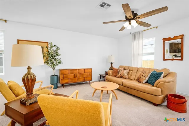 a living room with furniture and a chandelier