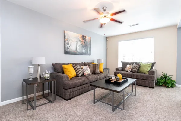 a living room with furniture and a large window