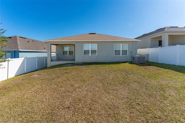 a view of a house with a backyard