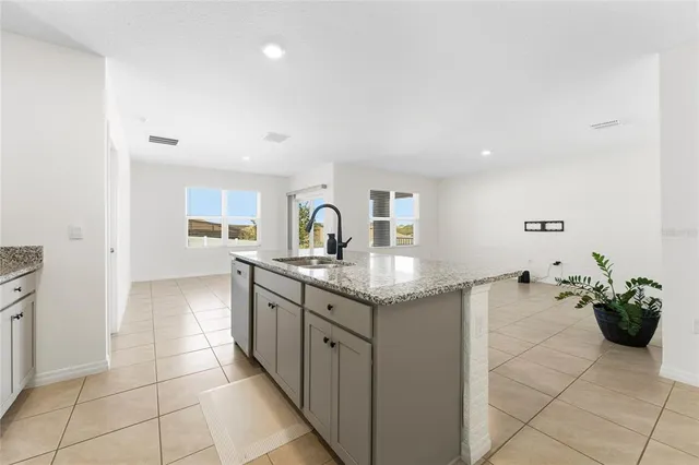 a kitchen with stainless steel appliances granite countertop a sink and cabinets