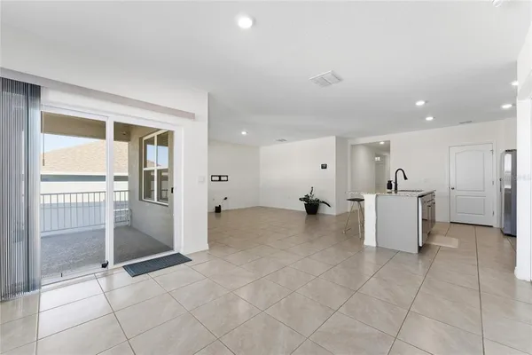 a view of kitchen with furniture and refrigerator