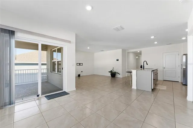 a view of kitchen with furniture and refrigerator