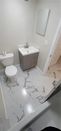 a bathroom with a sink a toilet and a mirror