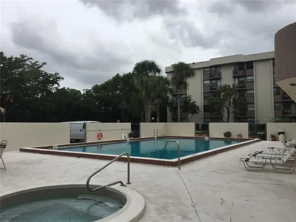 a view of a backyard with swimming pool