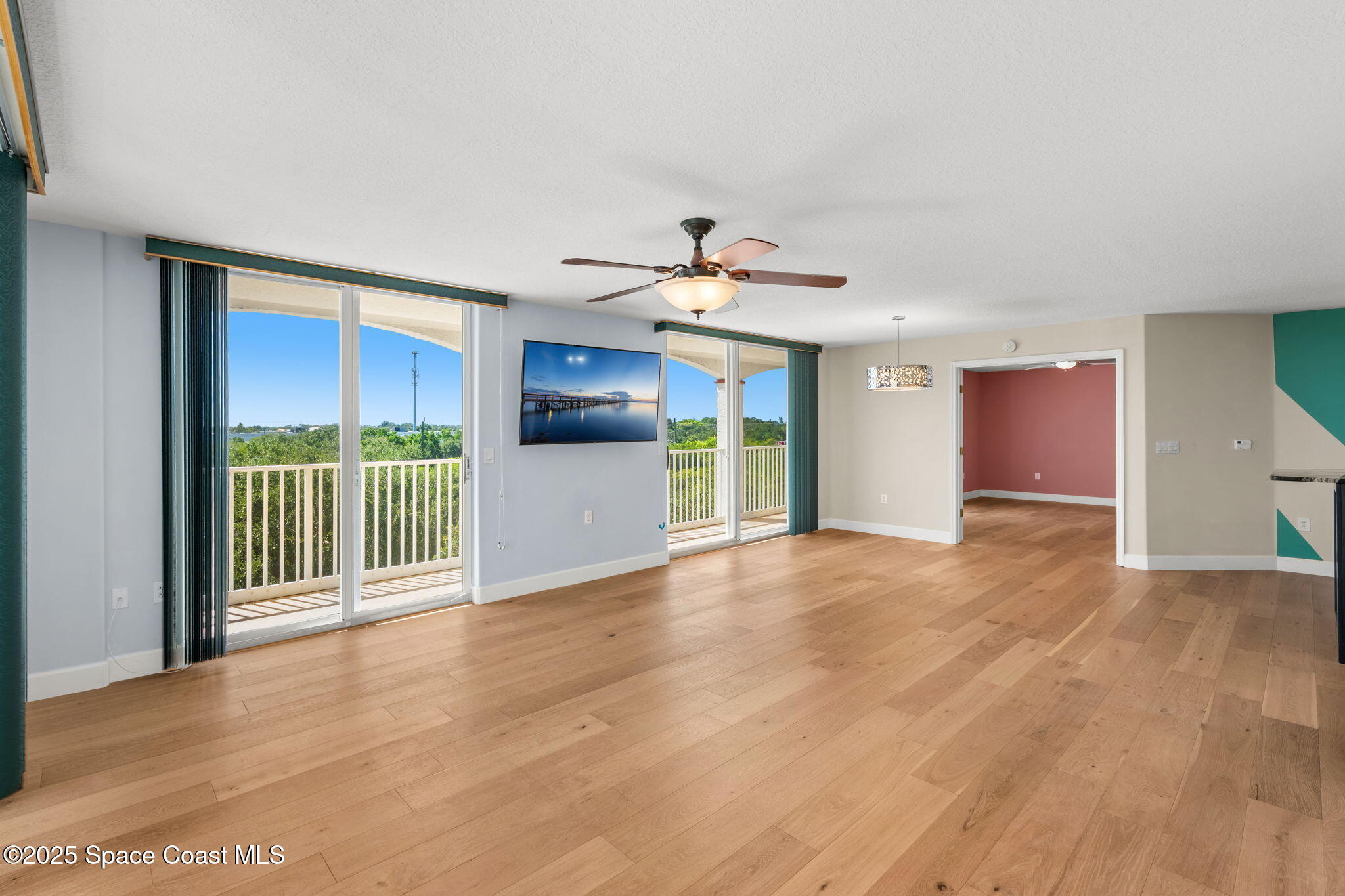 800 Del Rio Way, Unit 401 Merritt Island, FL 32953 - Photo 12 of 45 a view of a room with wooden floor and windows