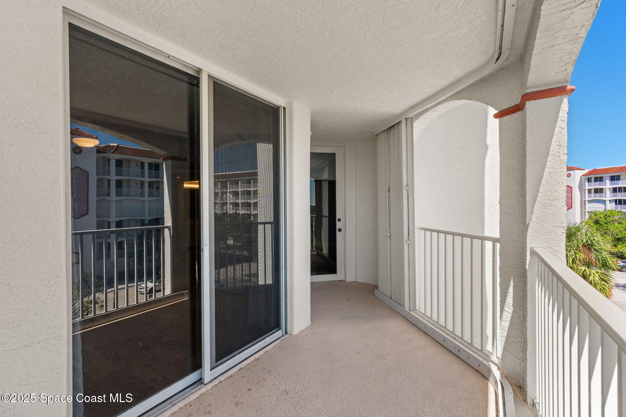 800 Del Rio Way, Unit 401 Merritt Island, FL 32953 - Photo 14 of 45 a view of a porch with a door and wooden floor