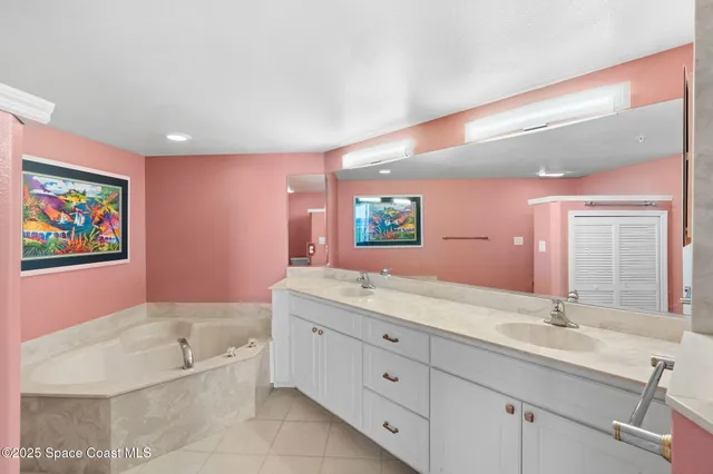 a bathroom with a granite countertop tub sink a mirror and a bathtub