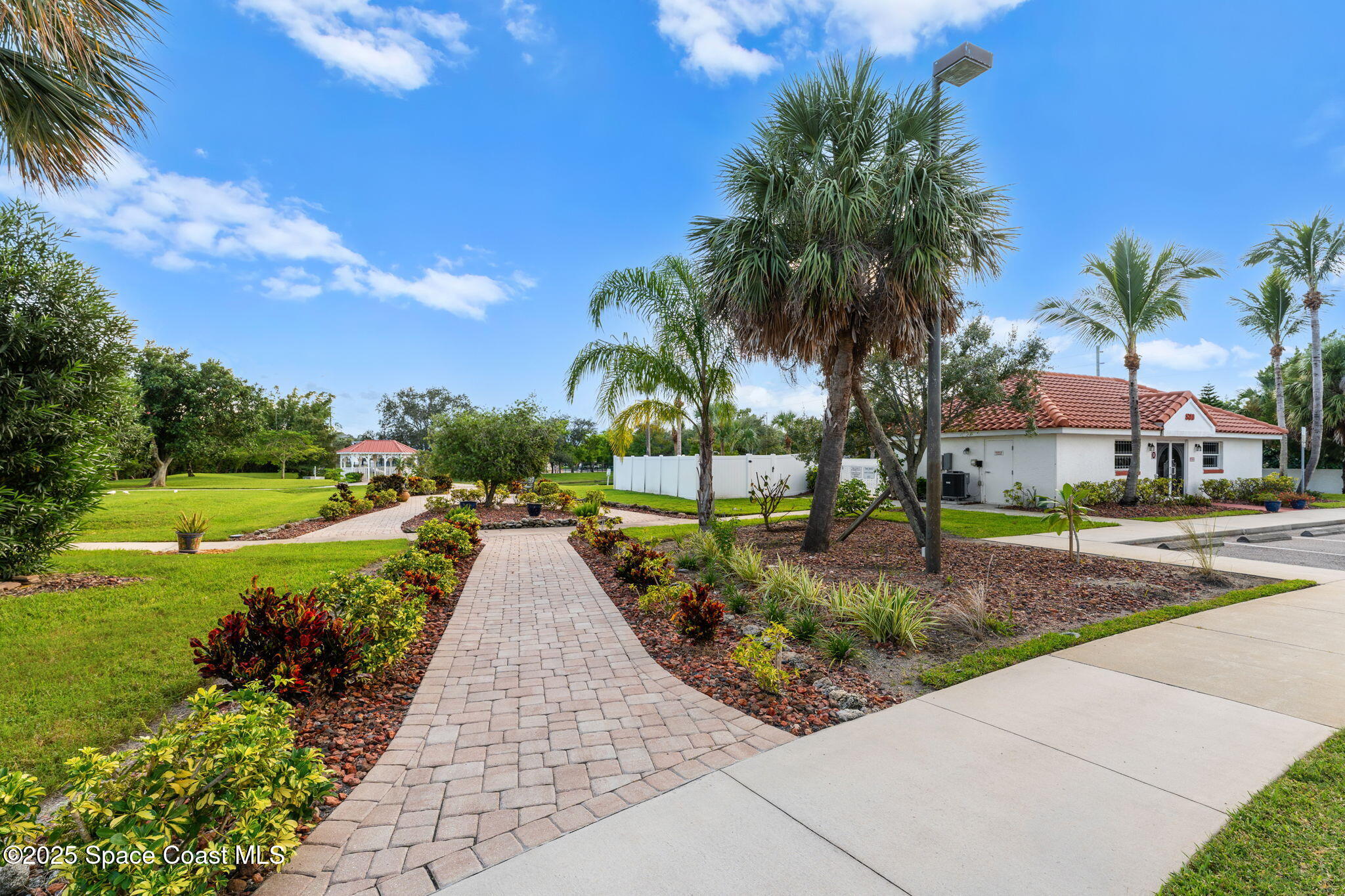 800 Del Rio Way, Unit 401 Merritt Island, FL 32953 - Photo 29 of 45 a view of a garden with palm trees