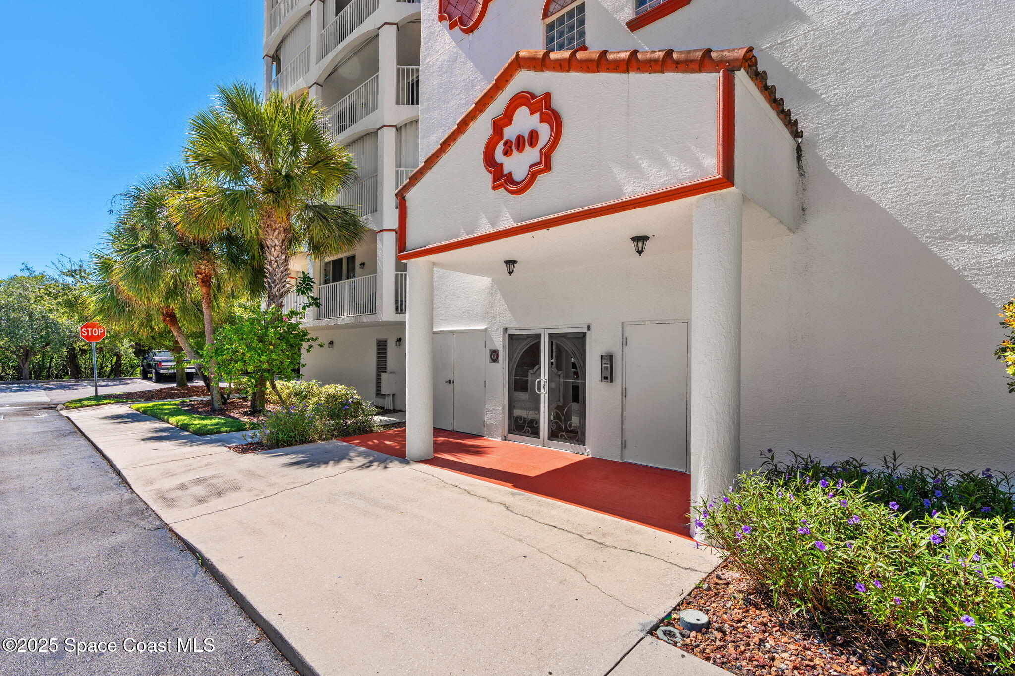 800 Del Rio Way, Unit 401 Merritt Island, FL 32953 - Photo 3 of 45 a view of a street with potted plants