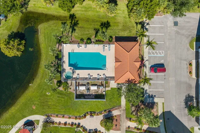 an aerial view of a house with a yard swimming pool a patio and outdoor seating