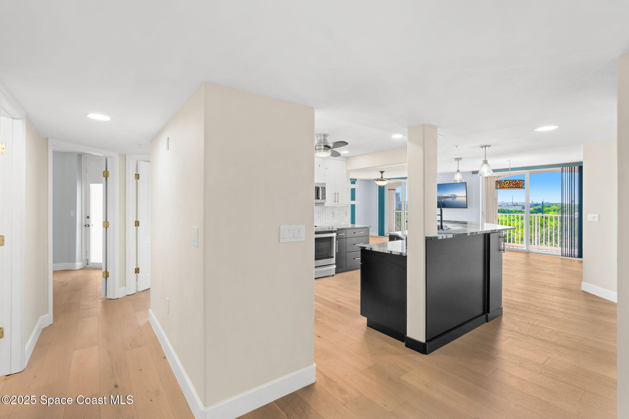 800 Del Rio Way, Unit 401 Merritt Island, FL 32953 - Photo 6 of 45 a living room with furniture and a dining table with kitchen view