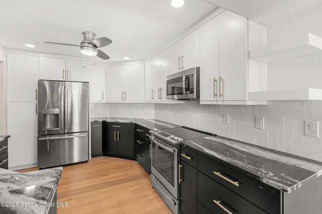 a kitchen with kitchen island a refrigerator stove and microwave