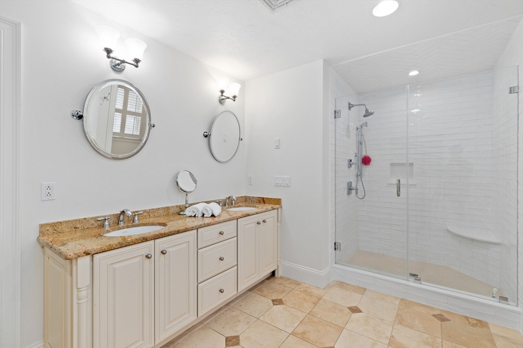 151 Tilden Road Scituate, MA 02066 - Photo 16 of 35 a bathroom with a granite countertop sink a mirror and a shower