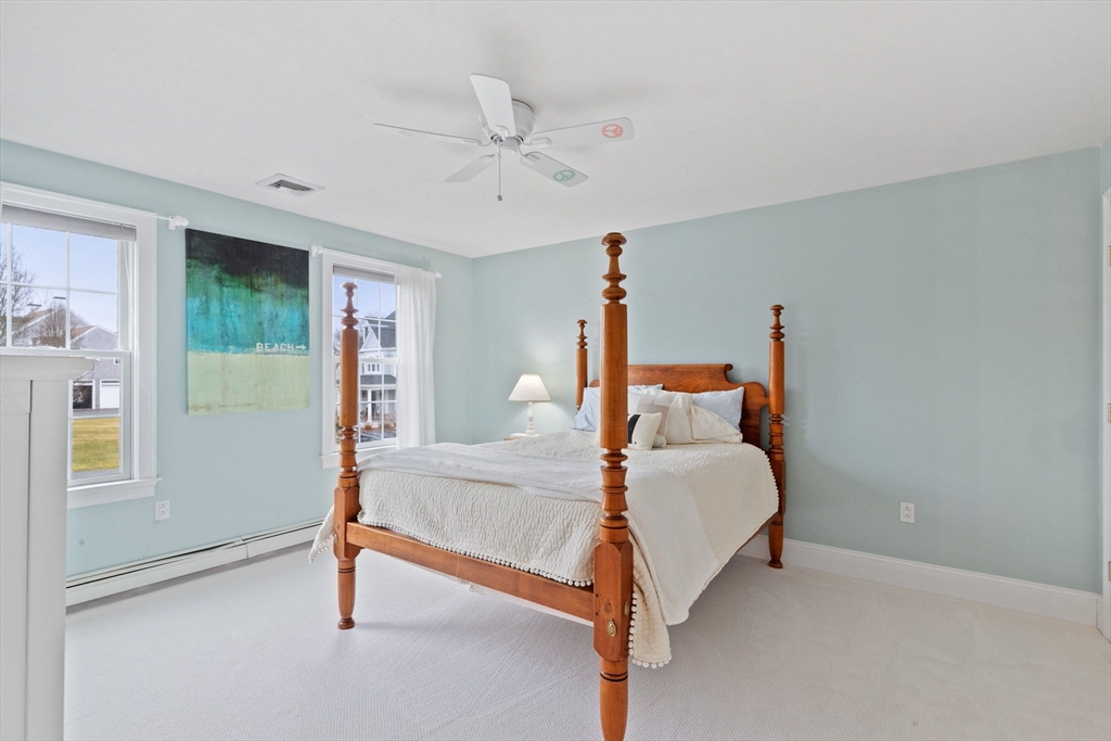 151 Tilden Road Scituate, MA 02066 - Photo 17 of 35 a bed room with a bed and a chandelier