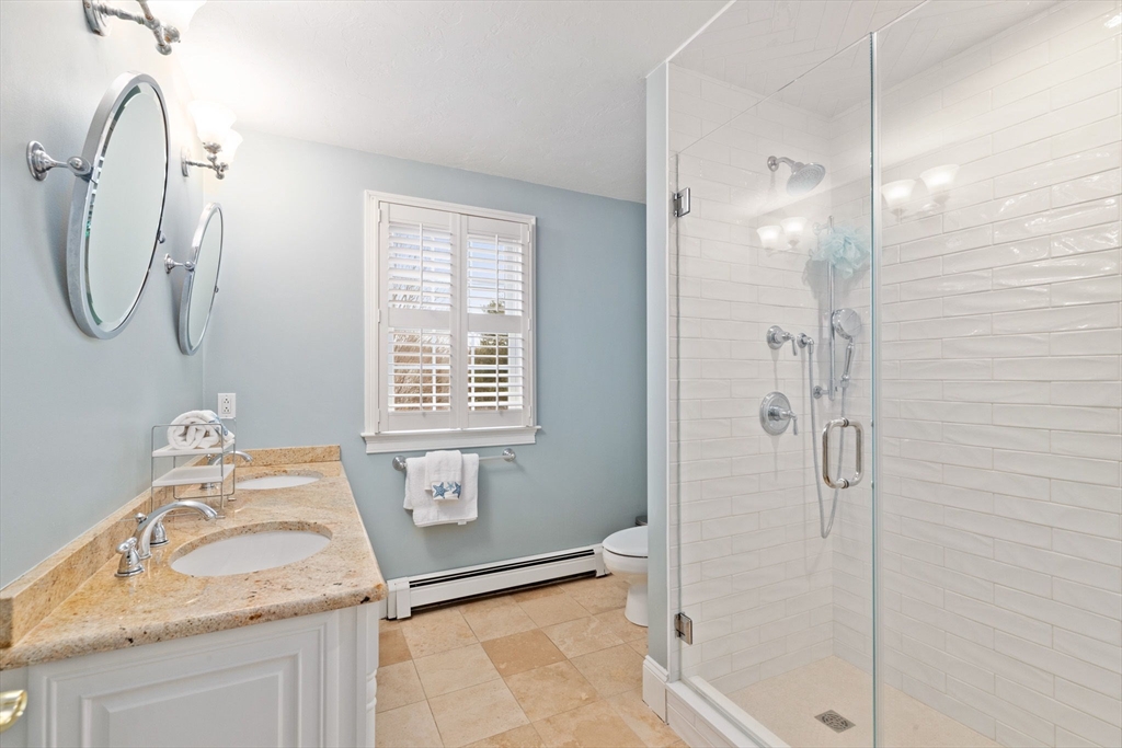 151 Tilden Road Scituate, MA 02066 - Photo 19 of 35 a bathroom with a granite countertop sink a shower and a mirror