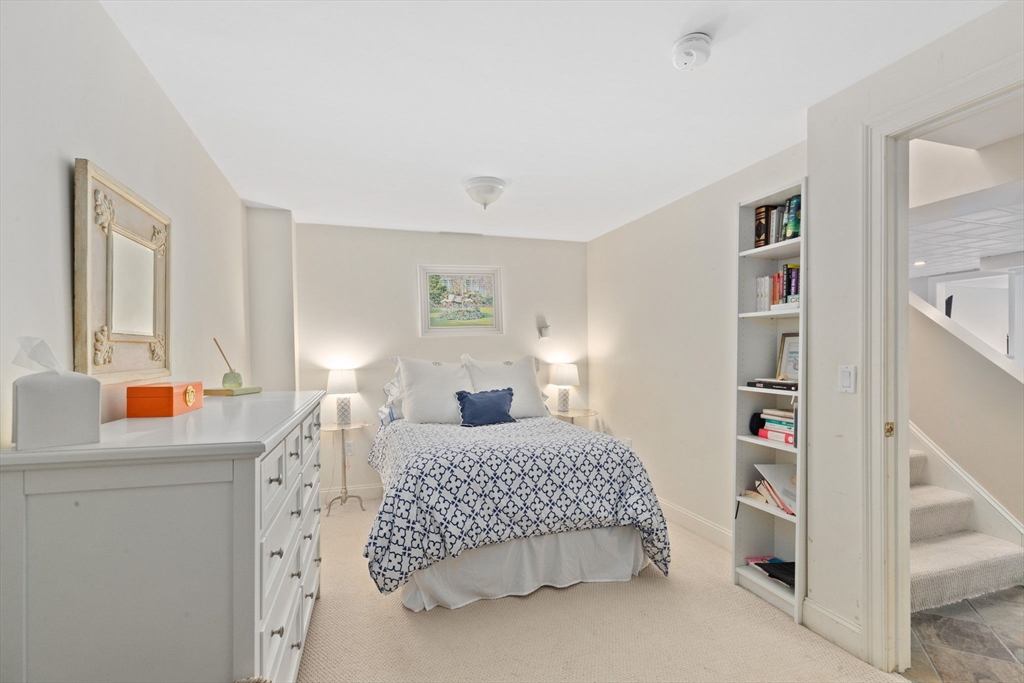 151 Tilden Road Scituate, MA 02066 - Photo 24 of 35 a bedroom with a bed and a cabinets