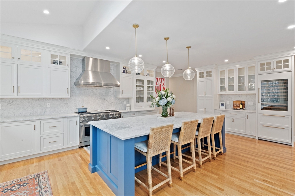 151 Tilden Road Scituate, MA 02066 - Photo 4 of 35 a kitchen with stainless steel appliances a dining table chairs stove and cabinets