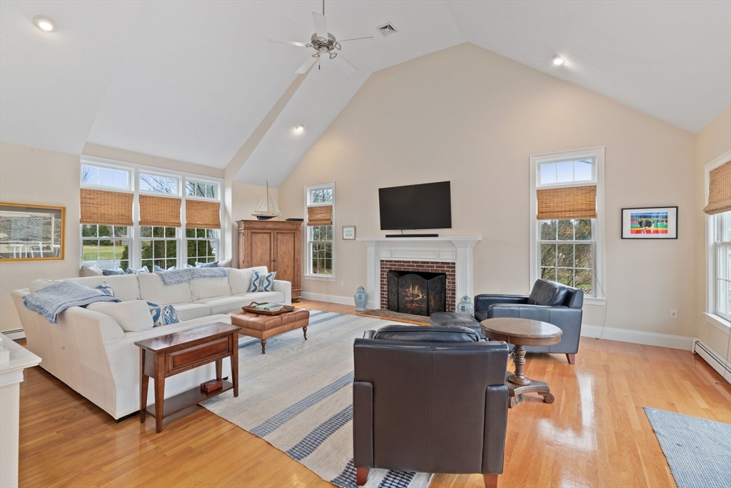 151 Tilden Road Scituate, MA 02066 - Photo 7 of 35 a living room with furniture fireplace and a table